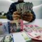 Ilustrasi pergerakan nilai tukar dolar Amerika Serikat terhadap rupiah di pasar keuangan.