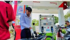 Petugas SPBU melayani pengisian BBM kepada pengendara.