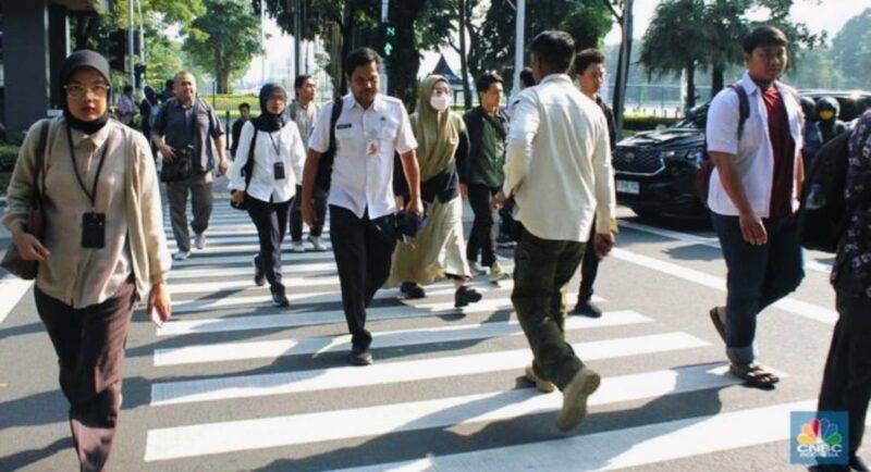 Sejumlah Aparatur Sipil Negara (ASN) berjalan menuju kantor di kawasan perkantoran pemerintah.