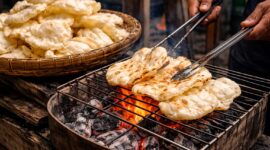 Kerupuk bakar khas Palembang yang dipanggang di atas bara api oleh pedagang tradisional.